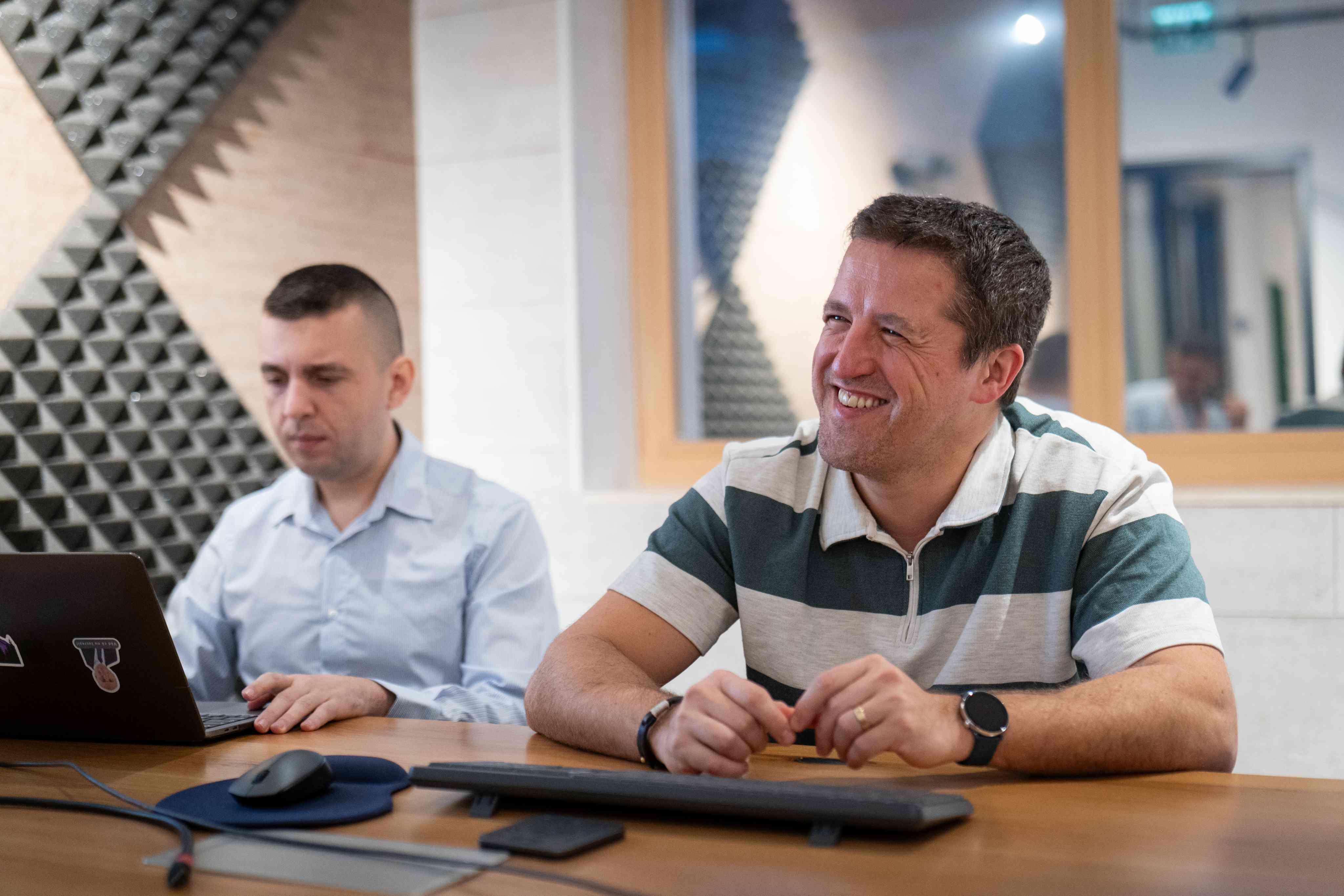Two engineers sharing a laugh during a working session