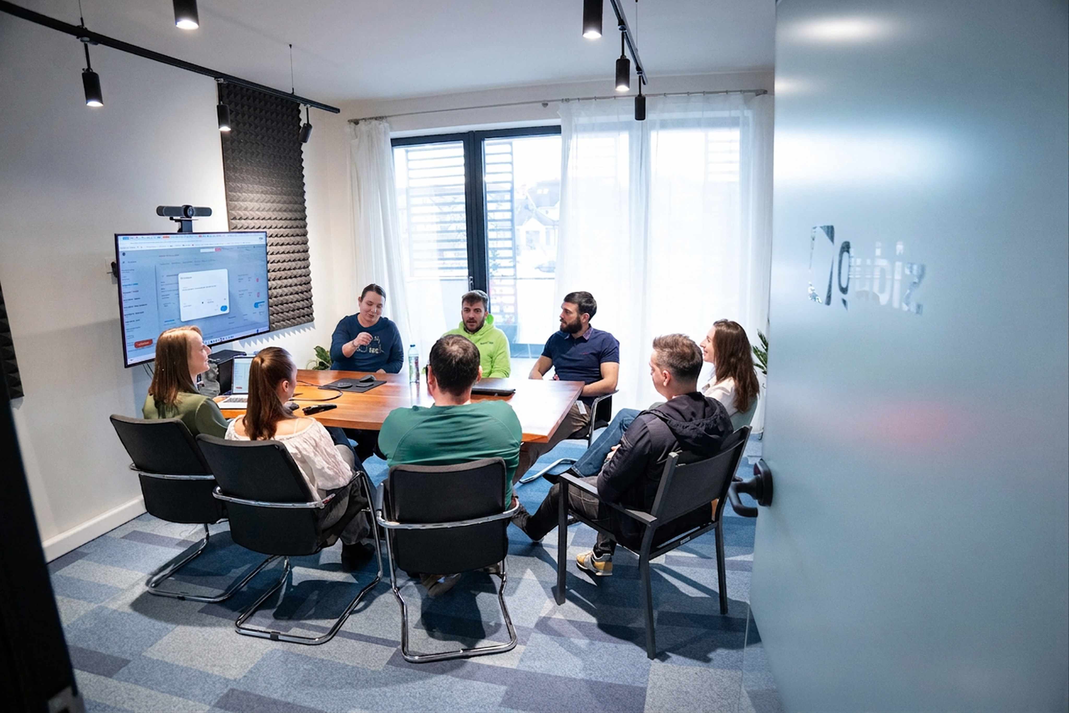 Qubiz team gathered around a conference table for a working session